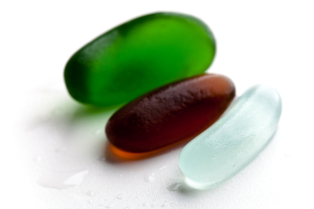 A close up of two different colored glass spoons