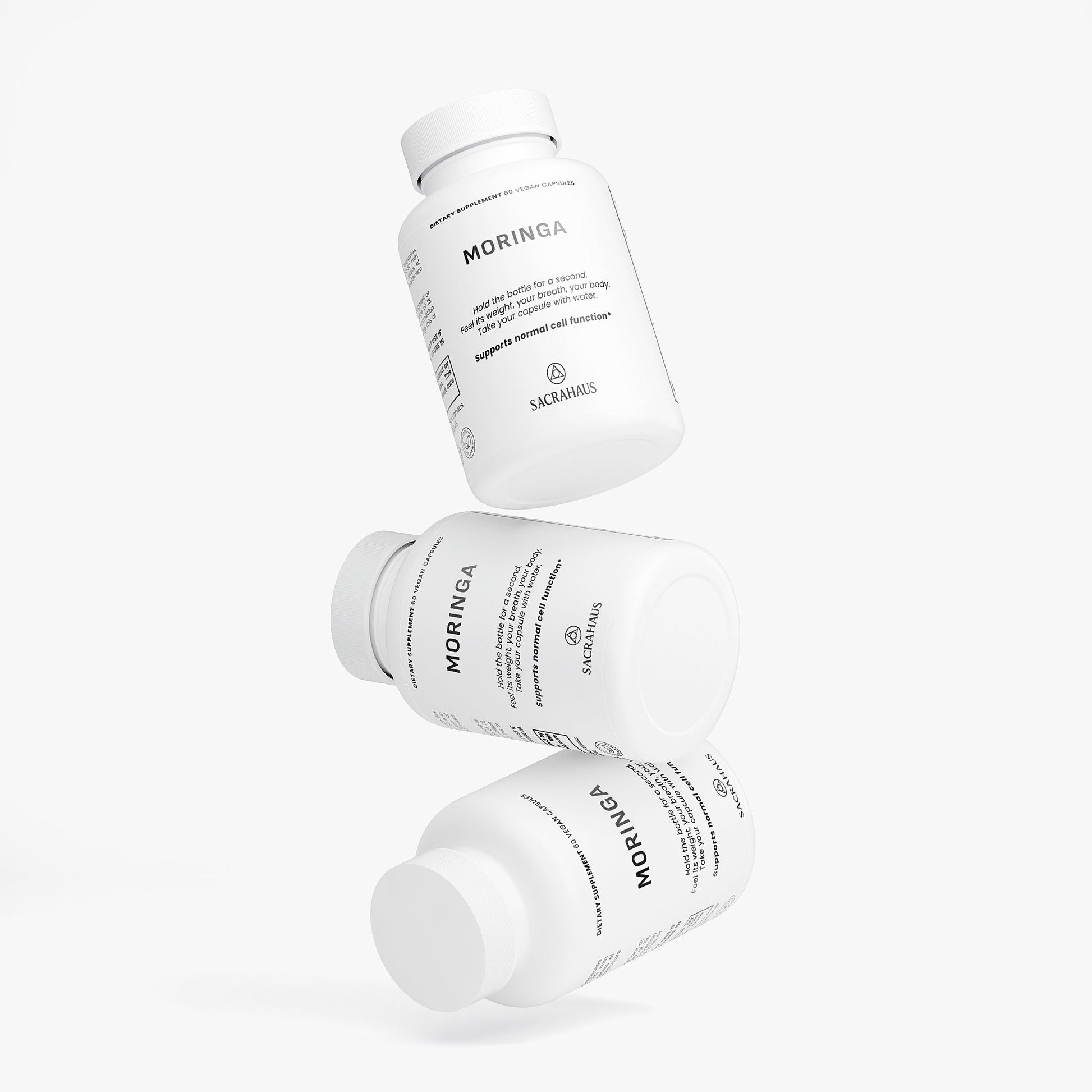 SACRAHAUS organic moringa capsules in white bottles stacked for easy supplement access